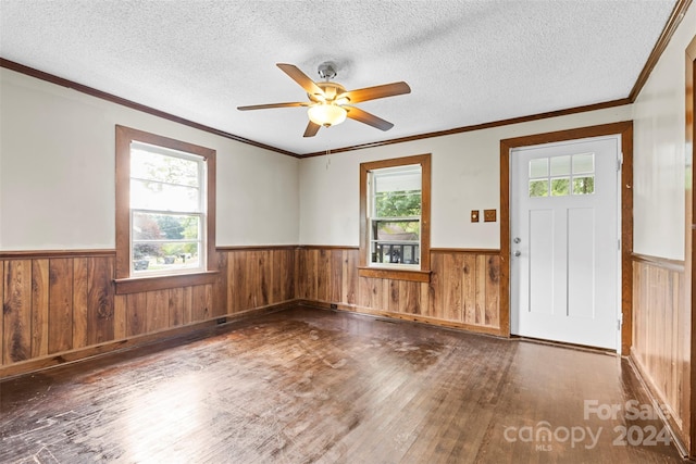 foyer entrance featuring ornamental molding, a textured ceiling, ceiling fan, and dark wood-type flooring