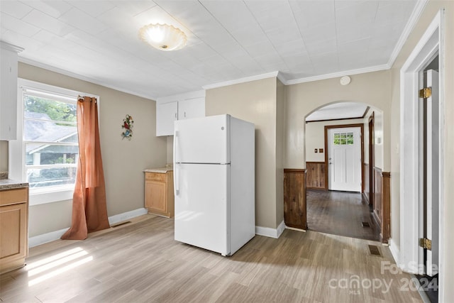 kitchen with crown molding, light wood-type flooring, and white refrigerator