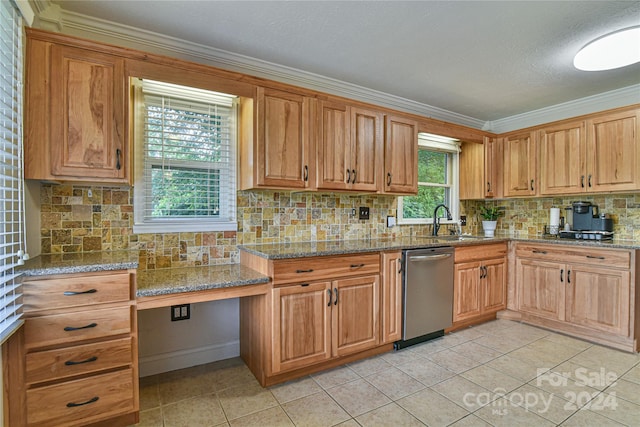 kitchen featuring light stone countertops, built in desk, stainless steel dishwasher, and sink