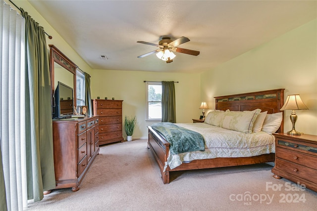 bedroom featuring light carpet and ceiling fan