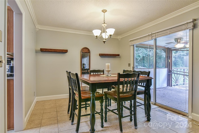 dining space with ceiling fan with notable chandelier, ornamental molding, a textured ceiling, and light tile patterned flooring