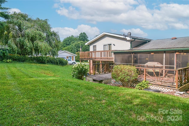 view of yard with a wooden deck and a sunroom