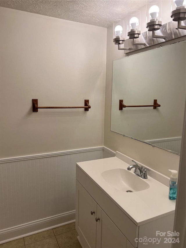 bathroom featuring an inviting chandelier, tile patterned floors, a textured ceiling, and vanity