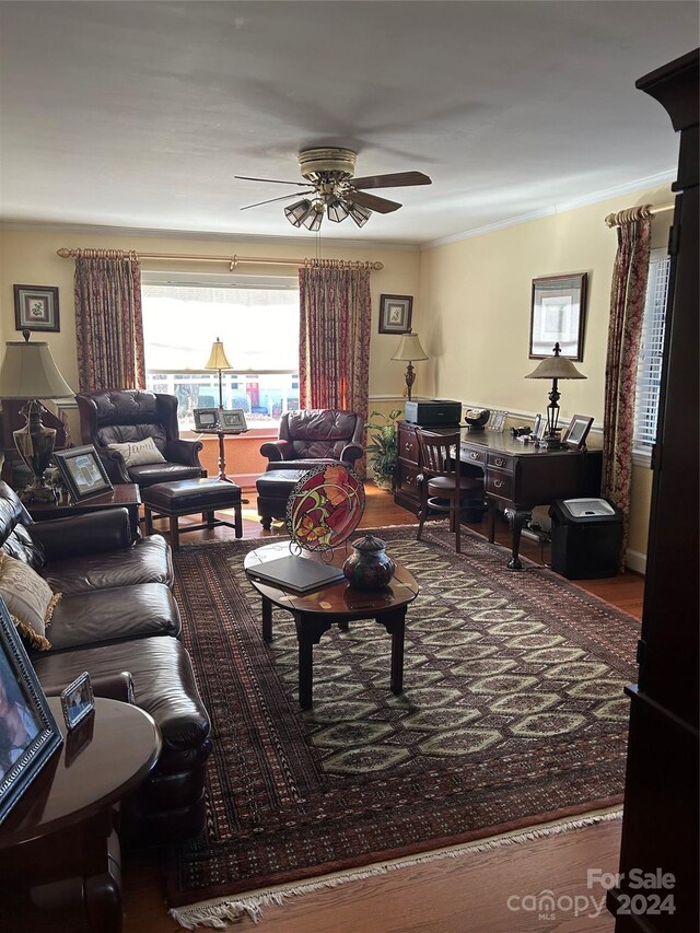 living room featuring ceiling fan, wood-type flooring, and ornamental molding