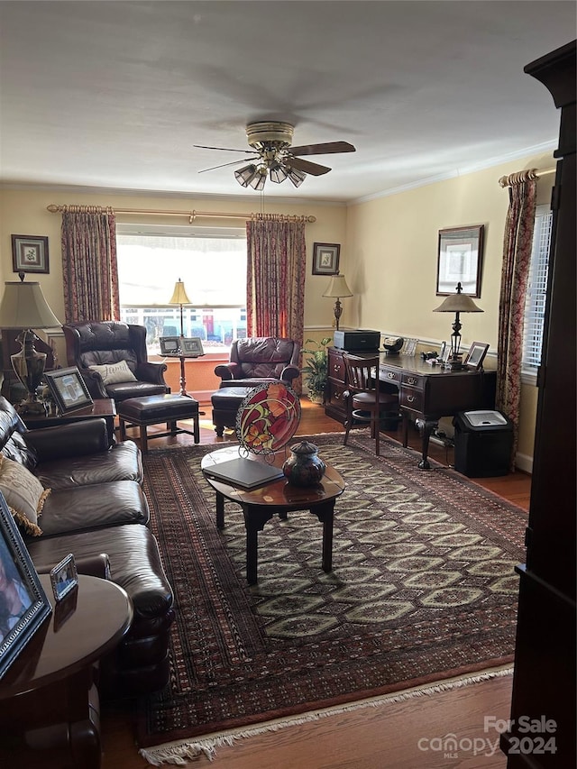 living room featuring crown molding and ceiling fan