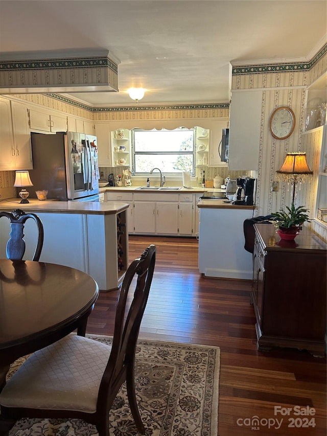 kitchen featuring white cabinetry, sink, stainless steel fridge, dark hardwood / wood-style flooring, and range