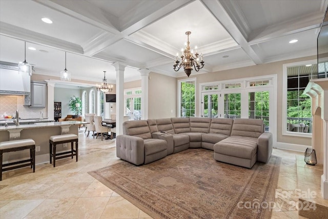 living room with coffered ceiling, ornate columns, a healthy amount of sunlight, and beamed ceiling