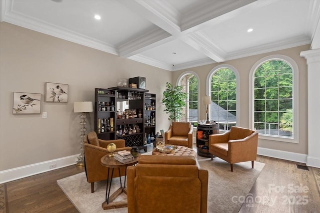 living area with coffered ceiling, hardwood / wood-style flooring, crown molding, and beamed ceiling