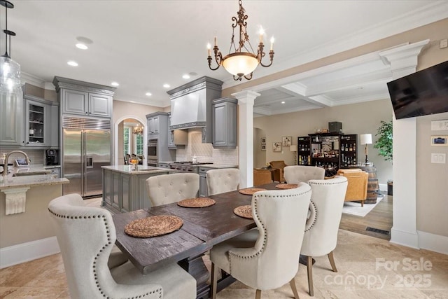 dining area with sink, ornate columns, crown molding, light tile patterned floors, and beam ceiling