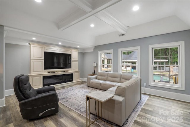 living room with coffered ceiling, hardwood / wood-style floors, plenty of natural light, and beamed ceiling