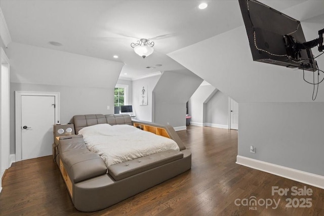 bedroom with lofted ceiling and dark wood-type flooring