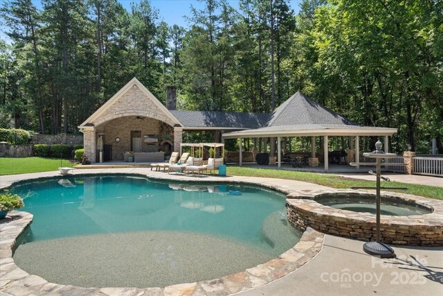 view of pool with a gazebo, an in ground hot tub, and a patio area