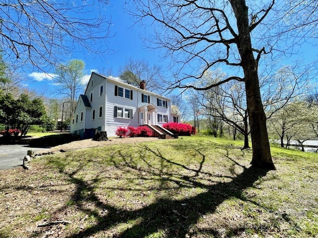 view of side of home featuring a lawn