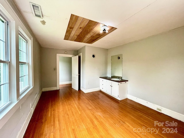 spare room featuring plenty of natural light and light hardwood / wood-style floors