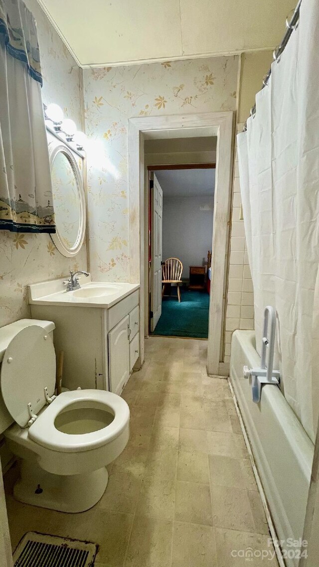 full bathroom with vanity, toilet, and shower / bath combo with shower curtain