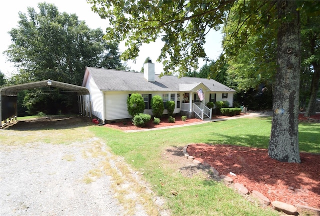 view of front of home with a front yard and a carport