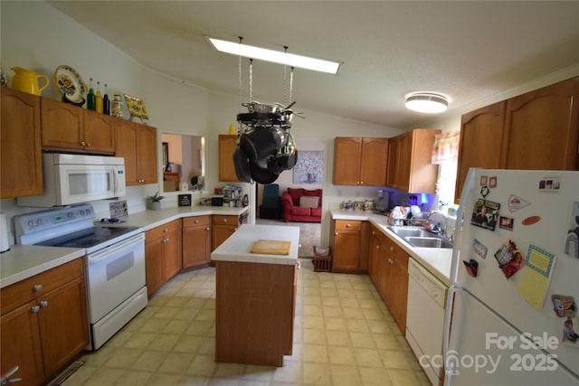 kitchen featuring white appliances, a kitchen island, vaulted ceiling, and sink