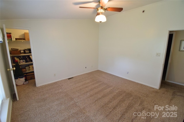 spare room featuring ornamental molding and light carpet