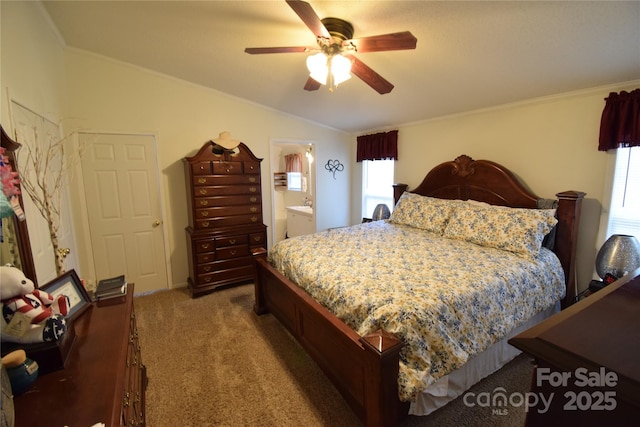 carpeted bedroom featuring connected bathroom, vaulted ceiling, ceiling fan, and ornamental molding