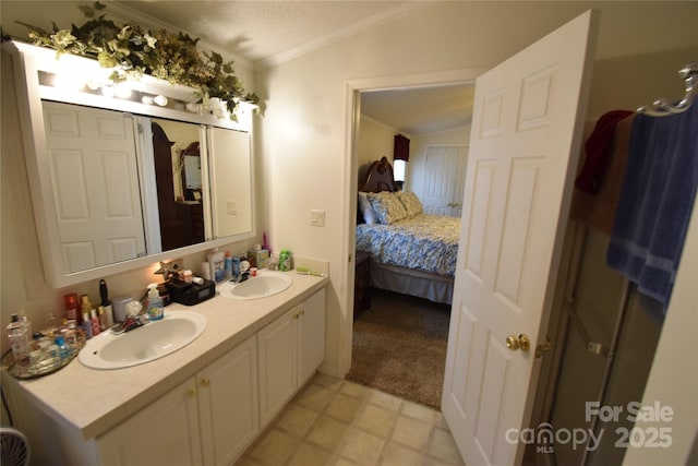 bathroom featuring a textured ceiling, vanity, vaulted ceiling, and ornamental molding