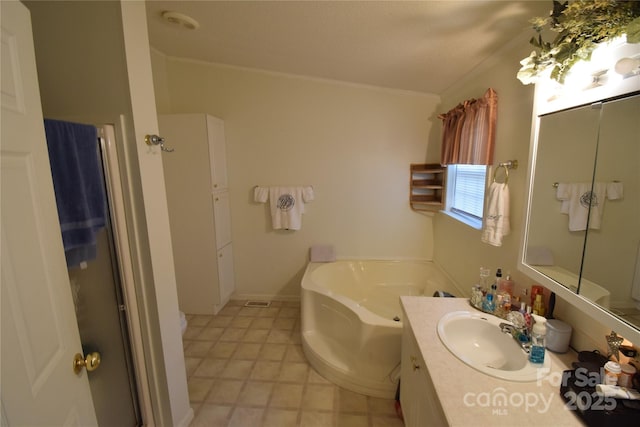 bathroom featuring crown molding, vanity, and shower with separate bathtub