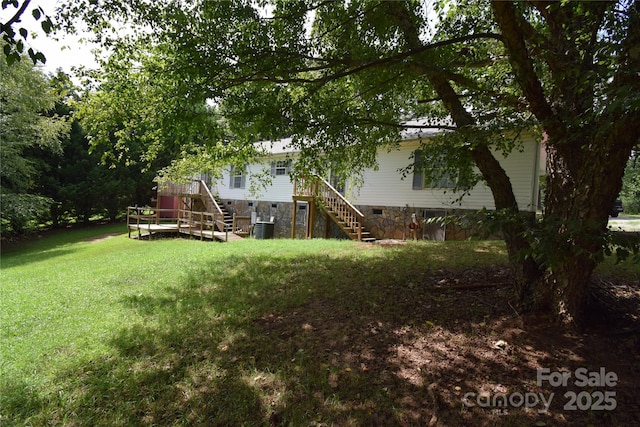 view of yard featuring central AC and a wooden deck