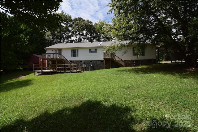 view of yard with cooling unit and a deck