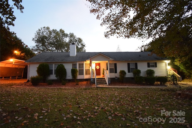 ranch-style house featuring a yard