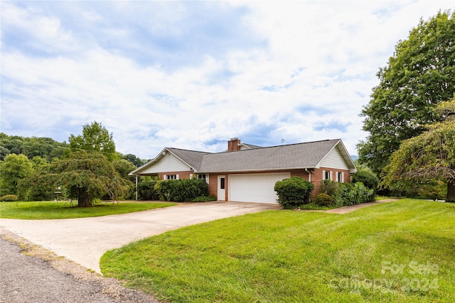 single story home with a front yard and a garage