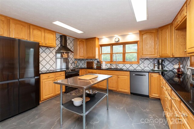 kitchen with range with electric stovetop, sink, wall chimney exhaust hood, stainless steel dishwasher, and black fridge