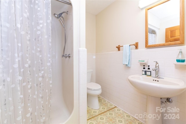 bathroom with tile walls, backsplash, toilet, and tile patterned floors