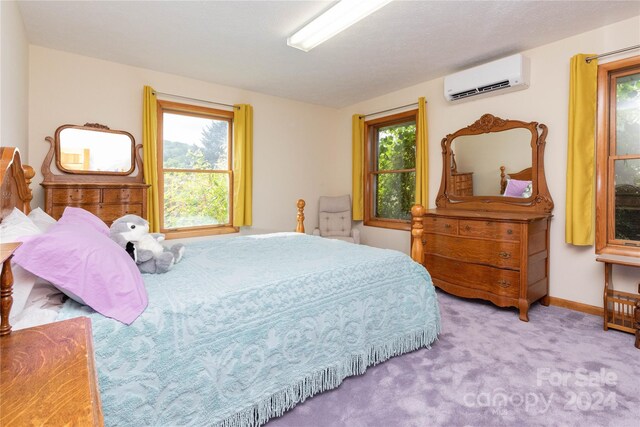 bedroom with carpet flooring and an AC wall unit