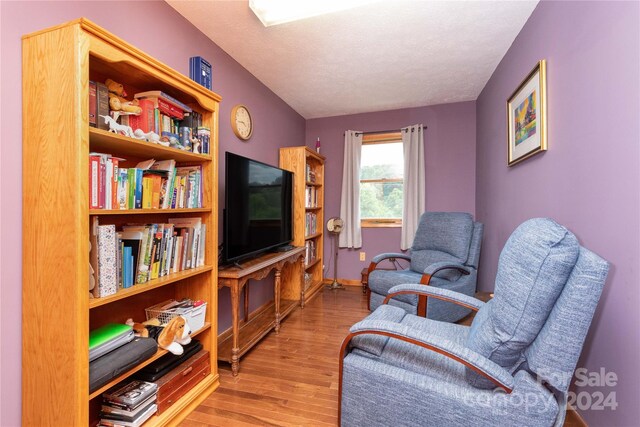 sitting room featuring a textured ceiling and light hardwood / wood-style flooring