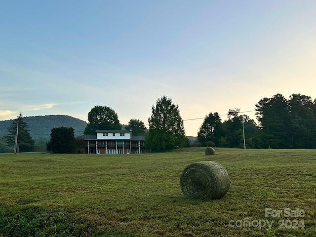 yard at dusk with a rural view