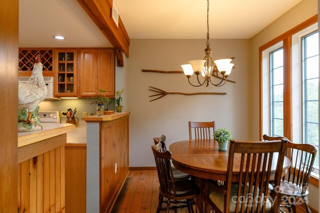 dining area featuring a chandelier and wood-type flooring