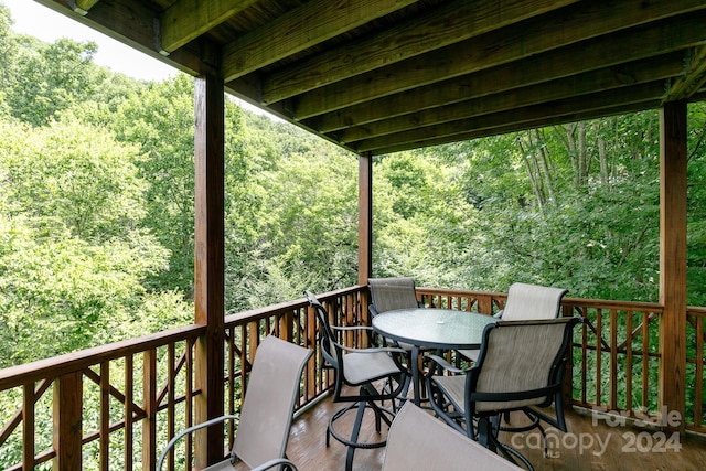 wooden deck featuring a forest view