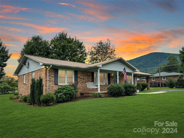 ranch-style house with a lawn