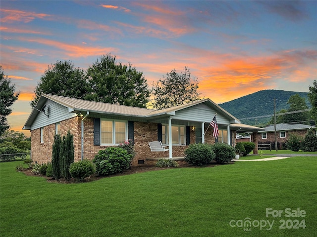 ranch-style house with a lawn