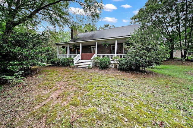9143 Sadlers Ridge Rd, Fort Mill, SC 29707 - view of front of property featuring a porch, a chimney, a front lawn, and brick siding