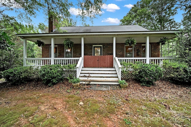 9143 Sadlers Ridge Rd, Fort Mill, SC 29707 - view of front of property featuring brick siding, covered porch, and a chimney
