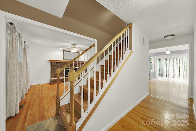 9143 Sadlers Ridge Rd, Fort Mill, SC 29707 - staircase with wood-type flooring, baseboards, a ceiling fan, and a textured ceiling
