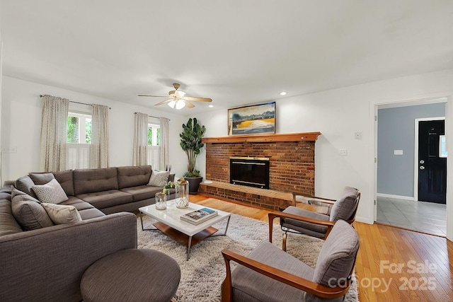 9143 Sadlers Ridge Rd, Fort Mill, SC 29707 - living room featuring a ceiling fan, light wood finished floors, a fireplace, and baseboards
