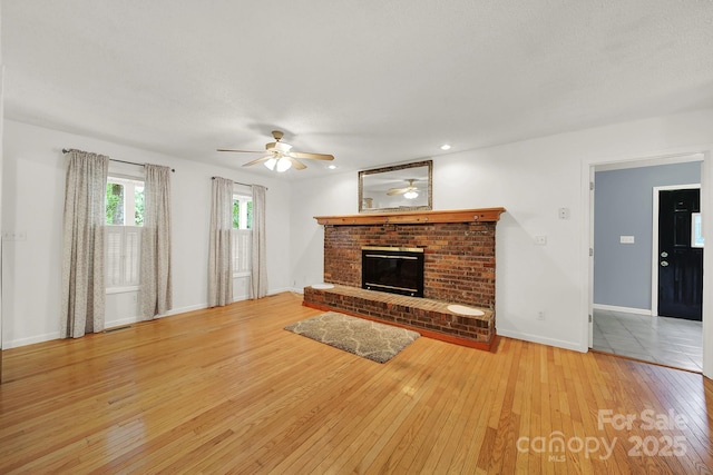 9143 Sadlers Ridge Rd, Fort Mill, SC 29707 - unfurnished living room with hardwood / wood-style floors, a ceiling fan, a fireplace, and baseboards