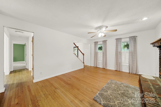9143 Sadlers Ridge Rd, Fort Mill, SC 29707 - unfurnished living room featuring stairway, a ceiling fan, light wood-type flooring, and baseboards