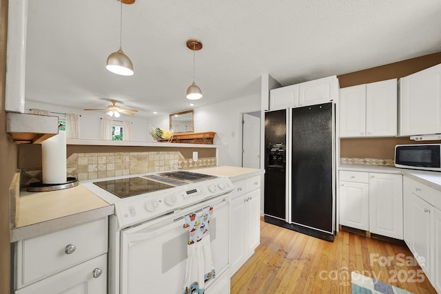 9143 Sadlers Ridge Rd, Fort Mill, SC 29707 - kitchen with white appliances, light countertops, and decorative light fixtures