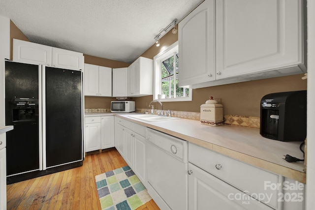 9143 Sadlers Ridge Rd, Fort Mill, SC 29707 - kitchen with white appliances, a sink, light wood finished floors, white cabinets, and a textured ceiling