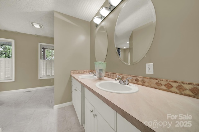 9143 Sadlers Ridge Rd, Fort Mill, SC 29707 - bathroom with double vanity, a textured ceiling, and baseboards