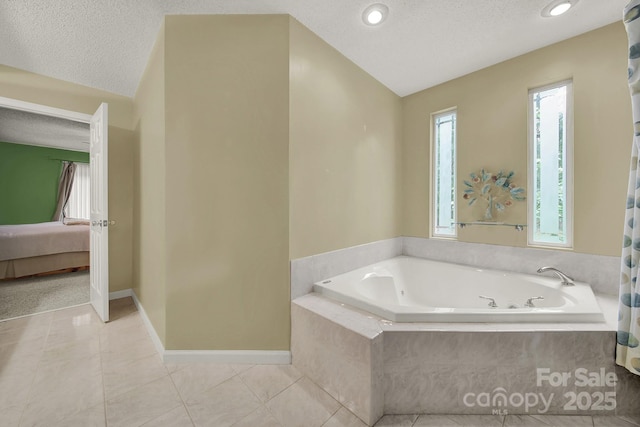 9143 Sadlers Ridge Rd, Fort Mill, SC 29707 - ensuite bathroom featuring a bath, tile patterned flooring, a textured ceiling, baseboards, and vaulted ceiling