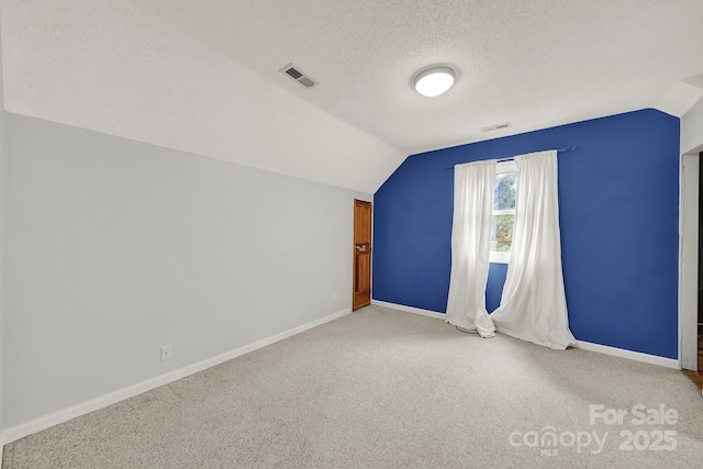 9143 Sadlers Ridge Rd, Fort Mill, SC 29707 - bonus room with vaulted ceiling, carpet, baseboards, and a textured ceiling