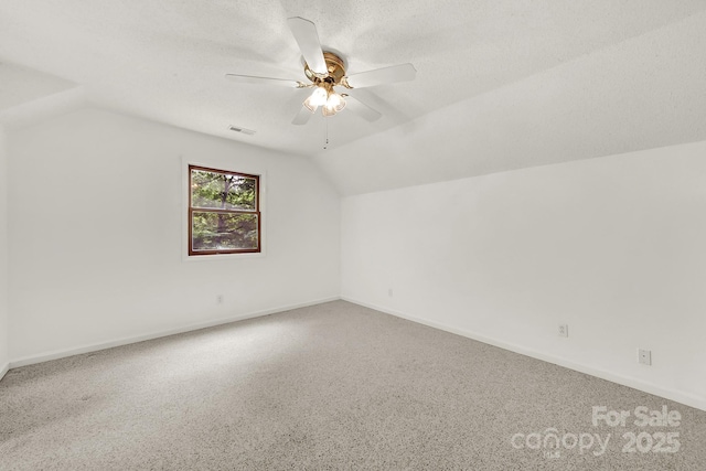 9143 Sadlers Ridge Rd, Fort Mill, SC 29707 - bonus room featuring lofted ceiling, a ceiling fan, baseboards, and a textured ceiling